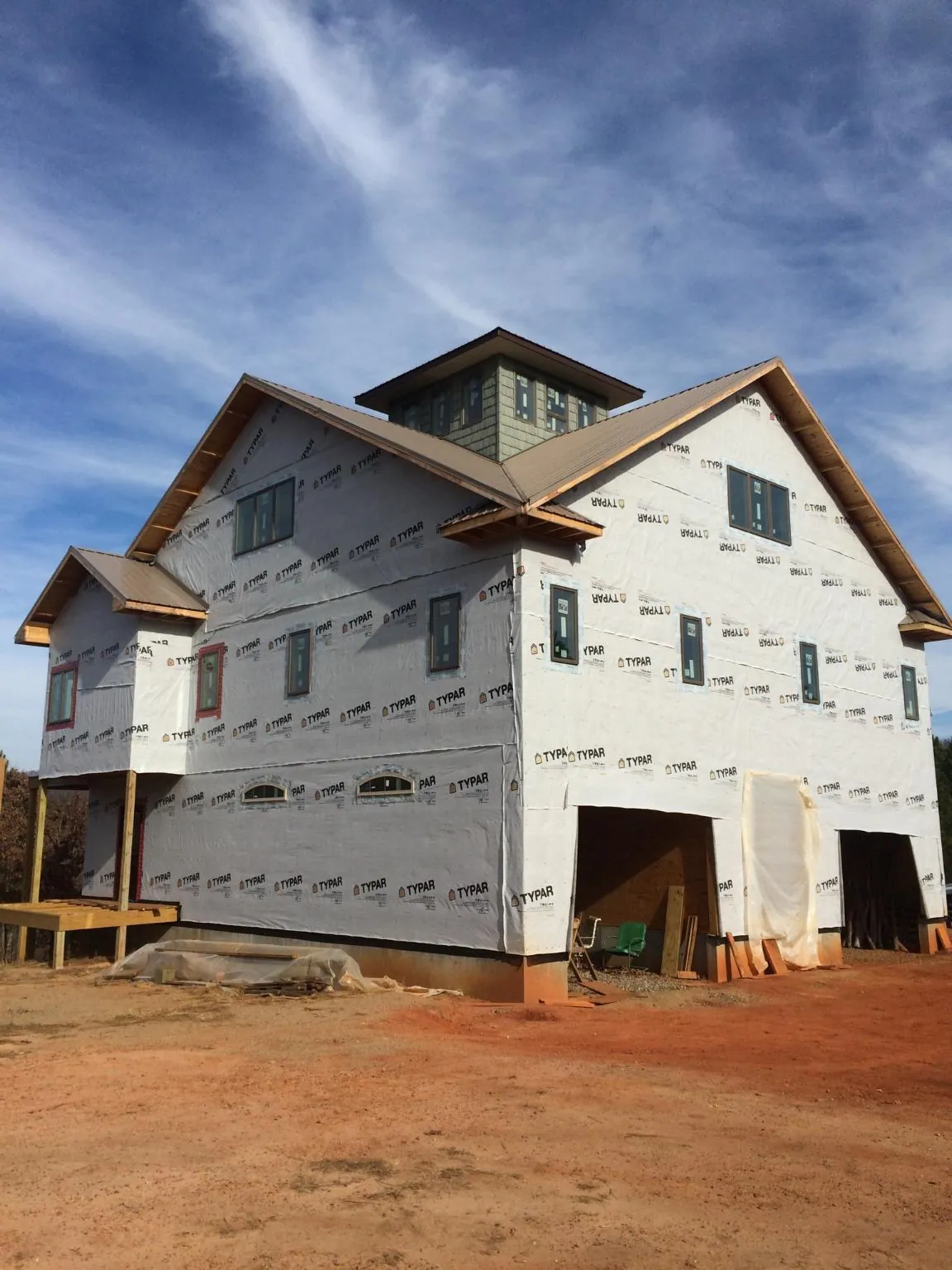 New two story house under construction with a cupola and gabled roofs in Chemung